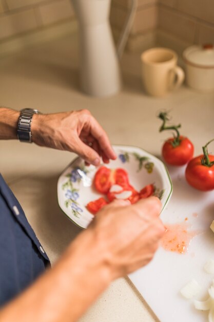 Mano dell&#39;uomo che prepara insalata fresca