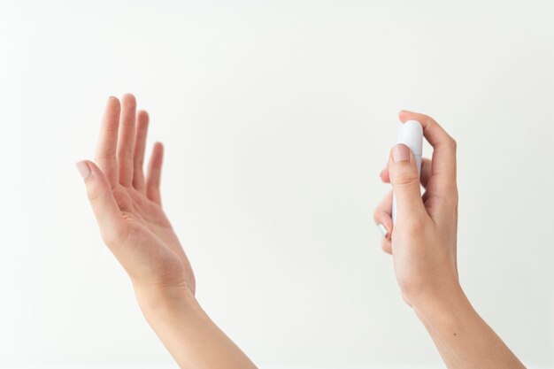 Mano utilizzando un disinfettante per le mani portatile