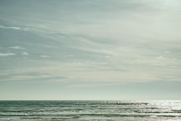 Mare su sfondo soleggiato con cielo nuvoloso Bellissimo cielo primaverile nuvoloso in una luminosa giornata di sole Pomeriggio turchese sulla spiaggia sabbiosa del Mar Nero Foto di alta qualità