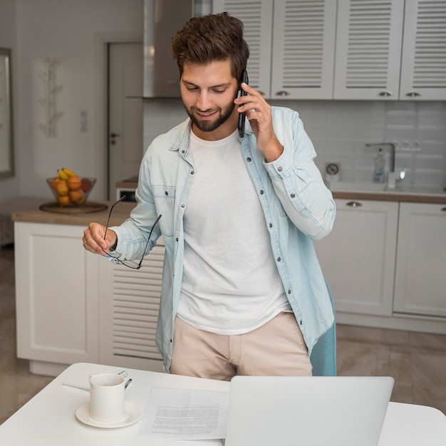 Maschio adulto casuale che comunica sul telefono