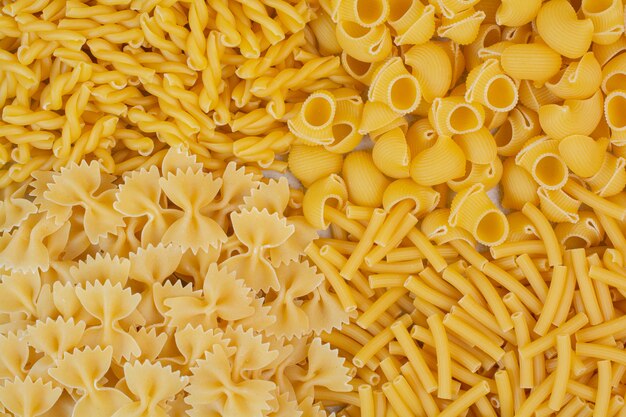 Mazzo di pasta cruda varia sulla superficie della pietra