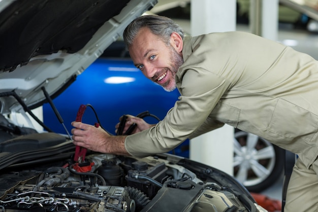 Meccanico di collegare i cavi jumper batteria per auto