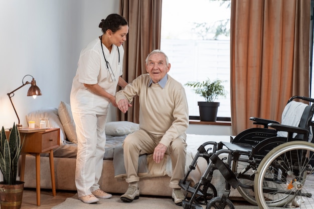 Medico che aiuta il paziente anziano