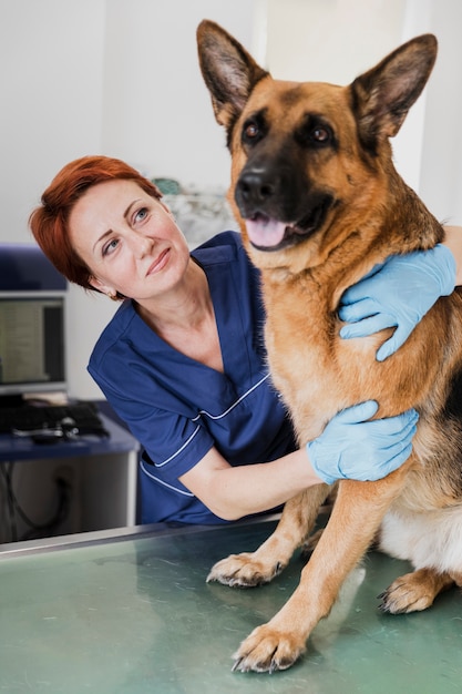 Medico di smiley del colpo medio che abbraccia cane sveglio