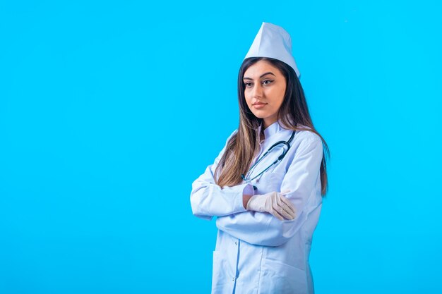 Medico femminile con lo stetoscopio che propone come professionista.