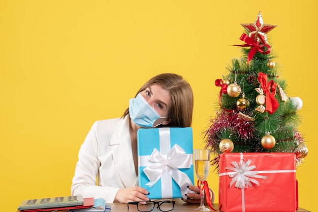 Medico femminile di vista frontale in maschera sterile con regali