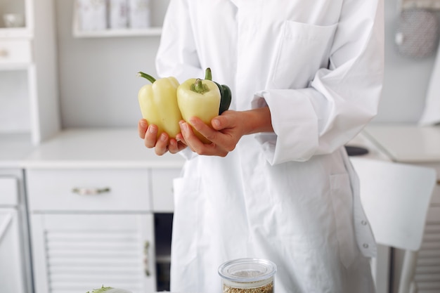 Medico in una cucina con verdure