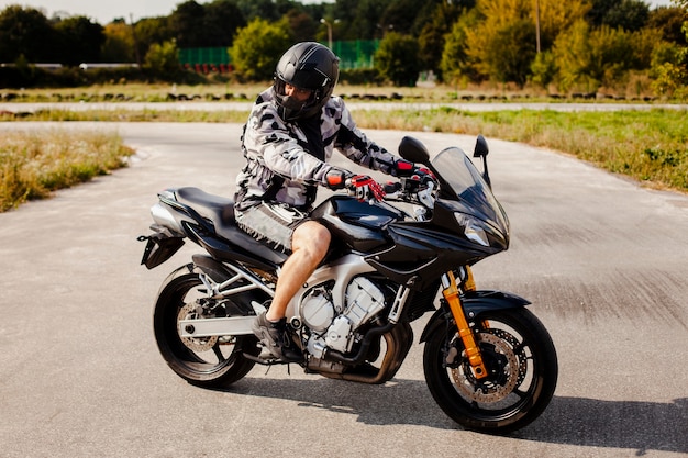 Motociclista sulla moto parcheggiata sulla strada