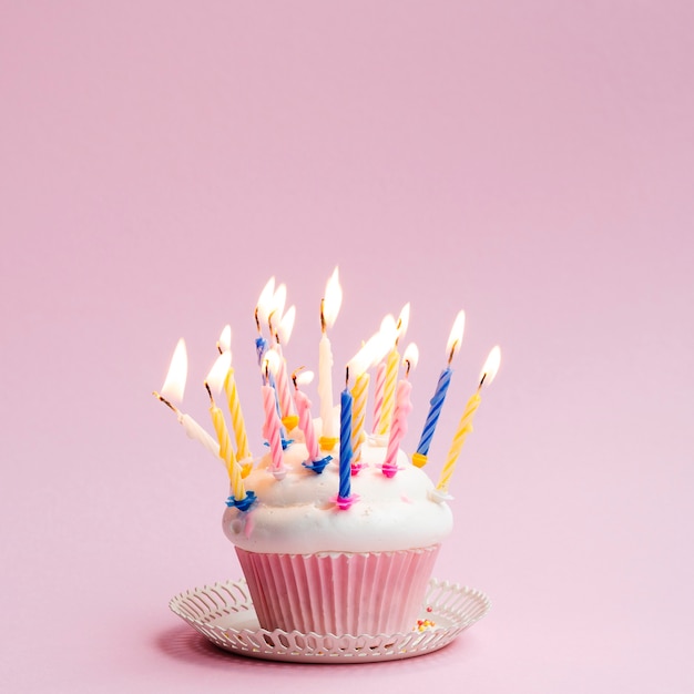 Muffin delizioso compleanno con candele colorate