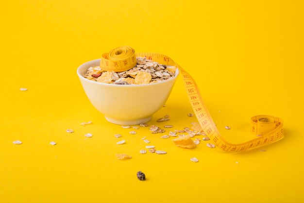 Nastro di misurazione vicino alla ciotola di muesli