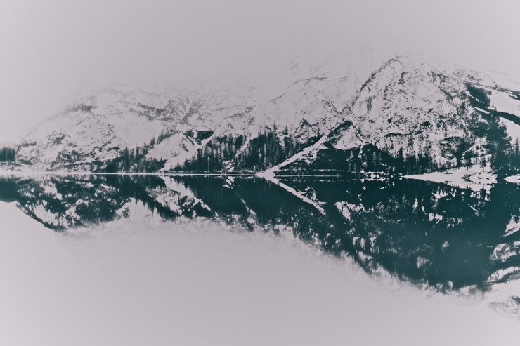 Paesaggio delle montagne innevate vicino al lago