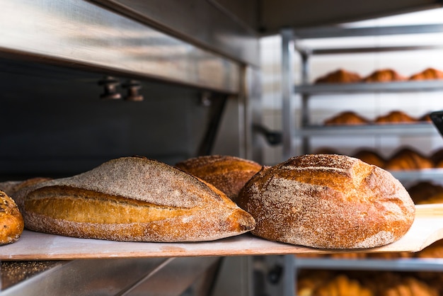 Pala in legno con pane appena sfornato dal forno