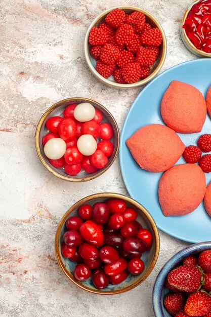 Pan di zenzero rosa vista dall'alto con frutta e bacche sul biscotto torta dolce torta di zucchero bianco scrivania