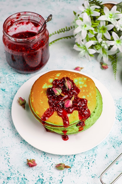 Pancake verdi con polvere di matcha con marmellata rossa, vista dall'alto