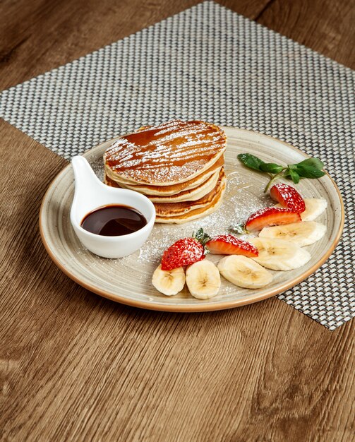 Pancakes con fette di frutta e marmellata