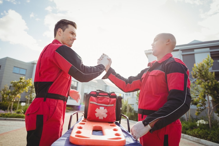 Foto gratuito paramedici sorridenti che stanno con le armi attraversate