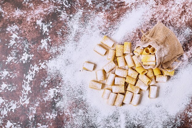 Pasta corta sulla tavola di legno.