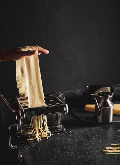 Pasticceria di taglio della persona del primo piano con la macchina