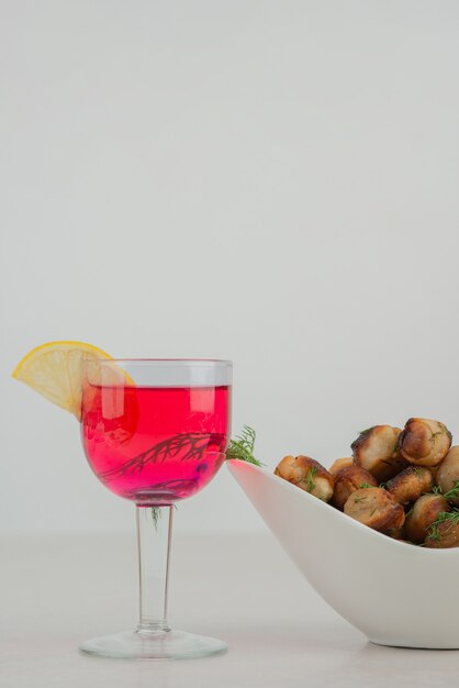 Patate fritte sulla zolla bianca con limonata.