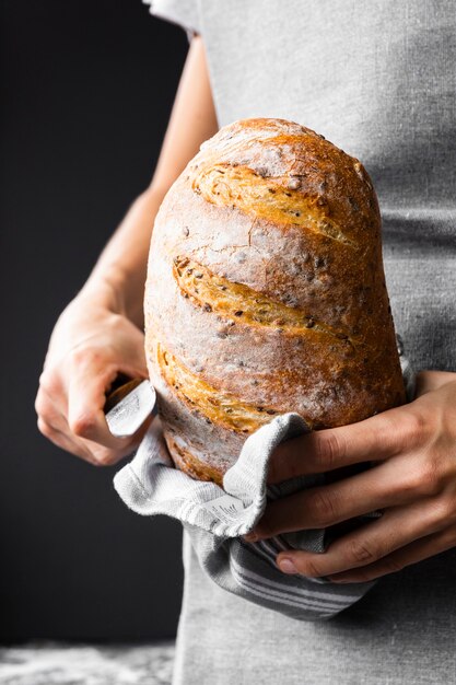 Persona in possesso di pagnotta di pane nutrizionale