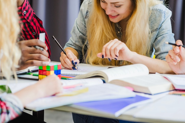 Persone allegre che collaborano mentre studiano