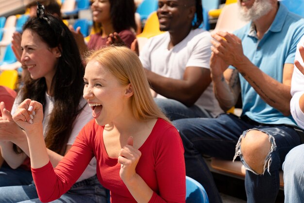 Persone che guardano una partita di calcio in una giornata di sole