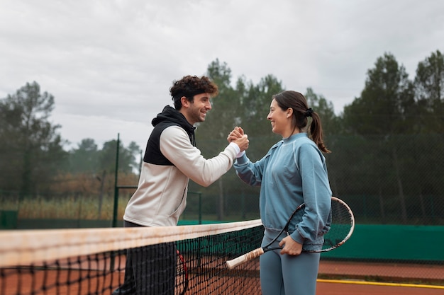 Persone che si preparano per la partita di tennis in inverno