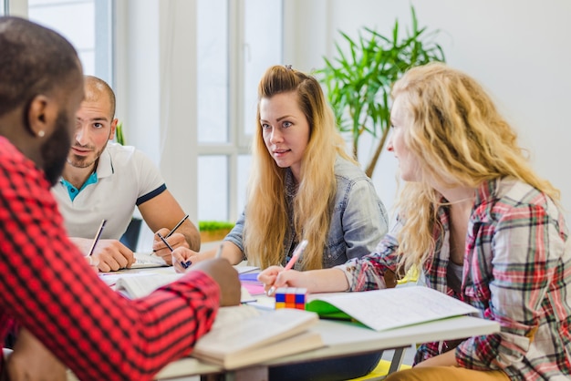 Persone con libri di testo che lavorano insieme