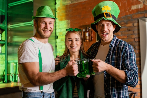 Persone felici che celebrano st. la giornata di patrick al bar