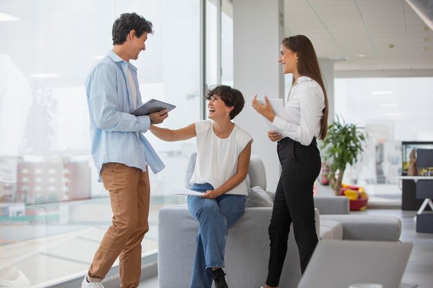 Persone sorridenti a tutto campo al lavoro