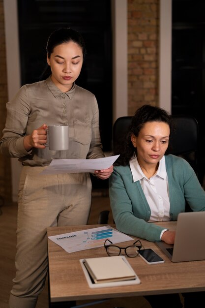 Persone stanche in ufficio che lavorano fino a tardi