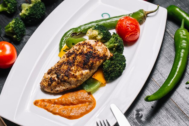 Petto di pollo alla griglia con peperoni broccoli e pomodoro con peperoncino verde piccante e salsa