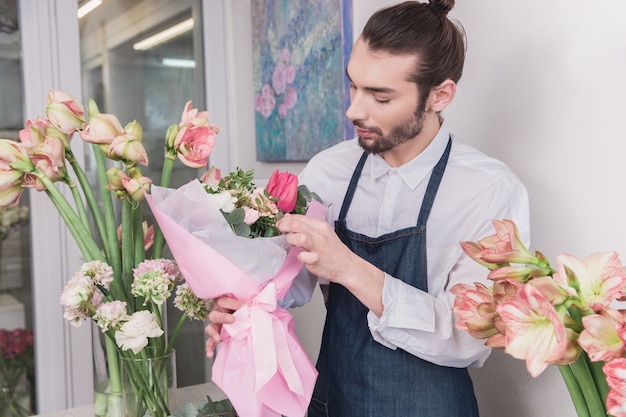 Piccola impresa. Fiorista maschio nel negozio di fiori. fare decorazioni e arrangiamenti