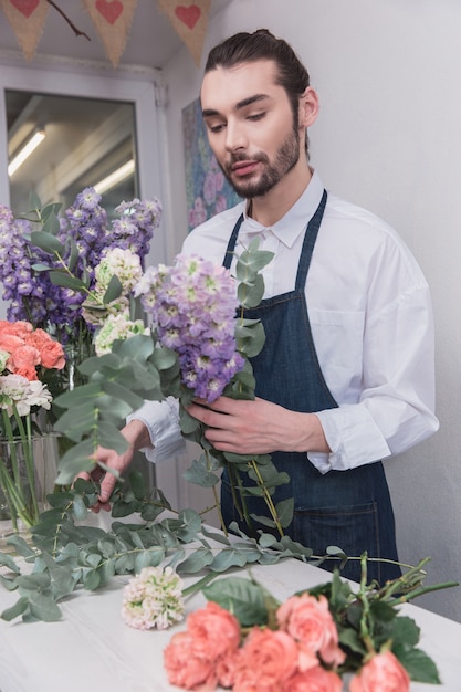 Piccola impresa. Fiorista maschio nel negozio di fiori.