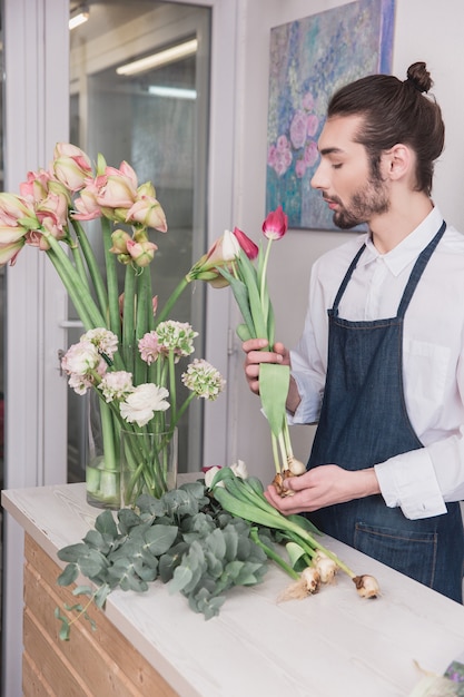 Piccola impresa. Fiorista maschio nel negozio di fiori.