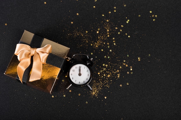 Piccola scatola regalo con orologio sul tavolo nero