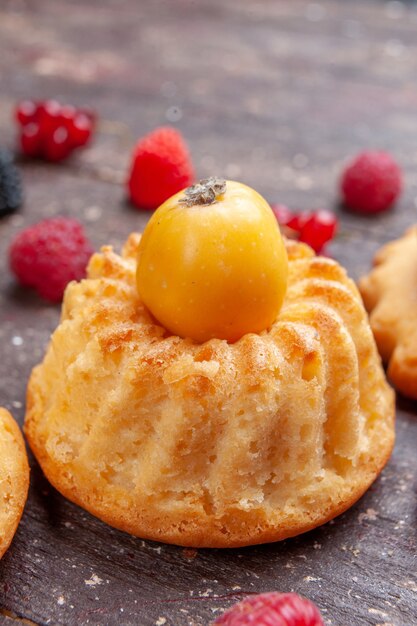 piccola torta con ciliegia gialla su marrone, biscotto da forno ai frutti di bosco