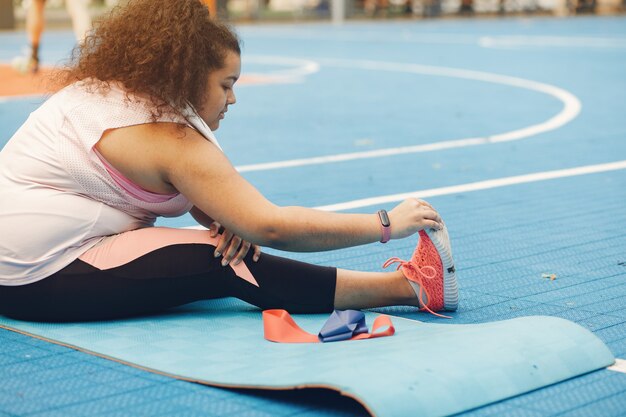 Più grande di una donna che fa esercizi di stretching