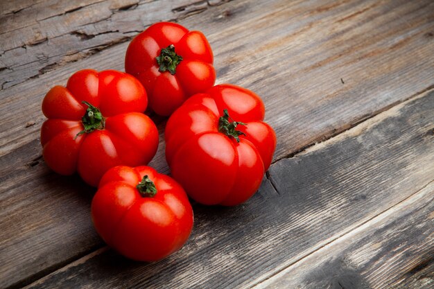 Pomodori di vista dell'angolo alto su fondo di legno scuro. orizzontale