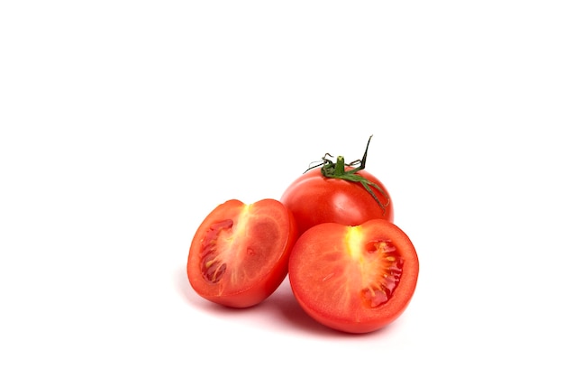 Pomodoro rosso succoso fresco con tagliato a metà isolato su priorità bassa bianca.