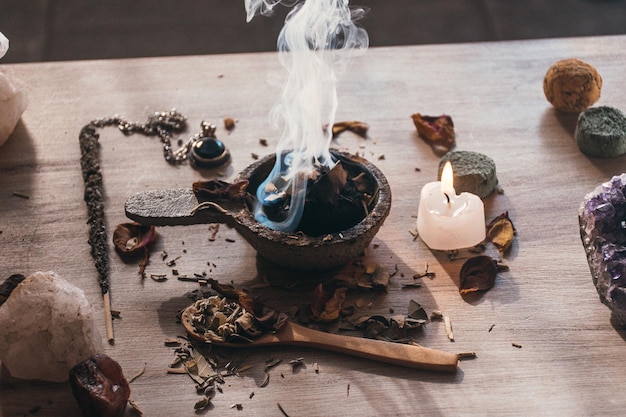 Portaincenso con resina di incenso a carbone ardente e mirra su un tavolo di legno rustico