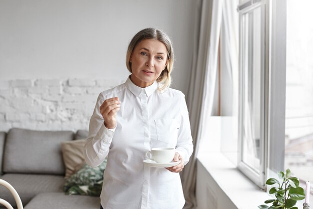 Posa di mezza età espressiva della donna