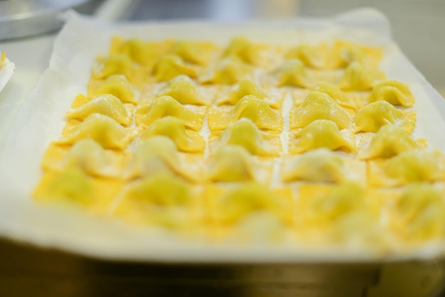 Preparazioni di tortelli italiani ripieni di ricotta, parmigiano e spinaci