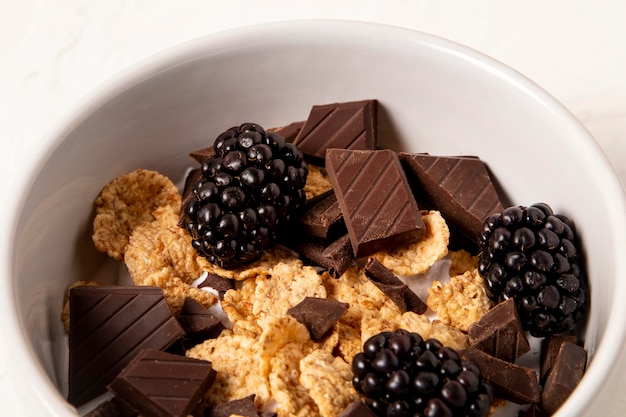 Primo piano della disposizione dei cereali sani della ciotola con il cioccolato