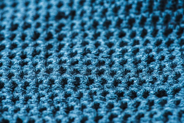 Primo piano della macro di struttura della tessile delle lane blu