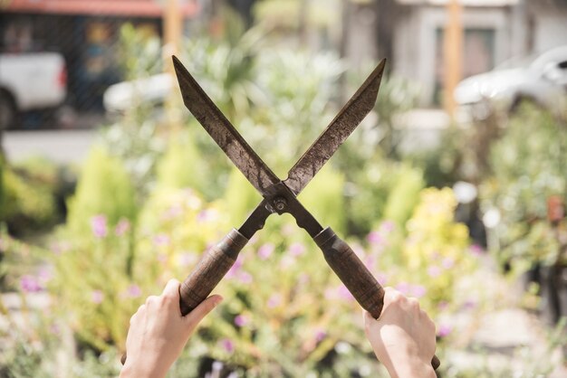 Primo piano delle forbici di giardinaggio della tenuta della mano di una donna