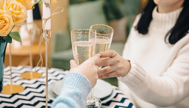 Primo piano di bicchieri con champagne in mani femminili