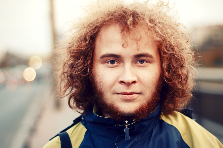 Foto gratuito primo piano di uomo con i capelli ricci e la barba