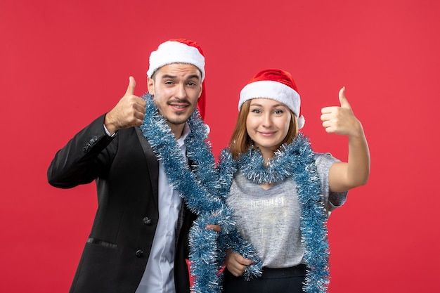 Primo piano su una giovane e bella coppia che indossa cappelli di Babbo Natale isolati