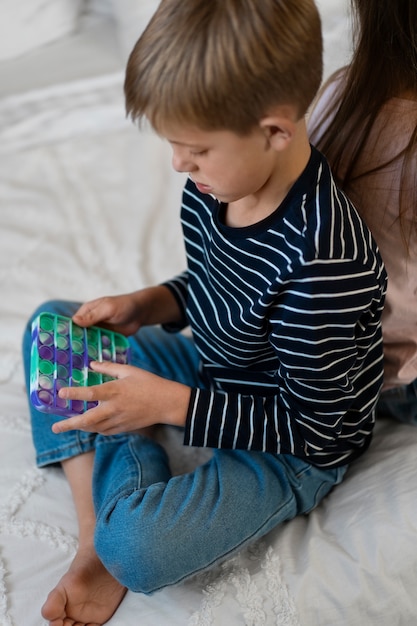 Primo piano sul bambino che gioca con il giocattolo pop it